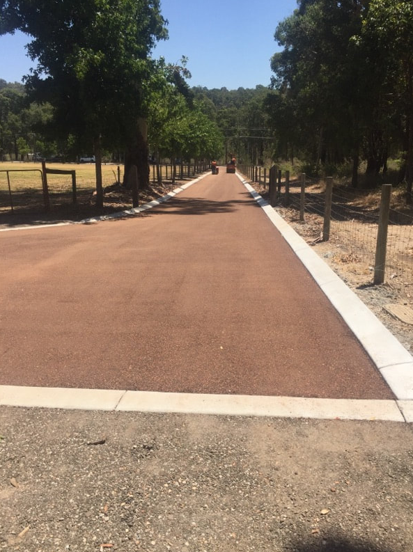 This is a photo of a hot spray & seal bitumen roadway which is in the process of being installed by Beaudesert Asphalt & Bitumen Surfacing